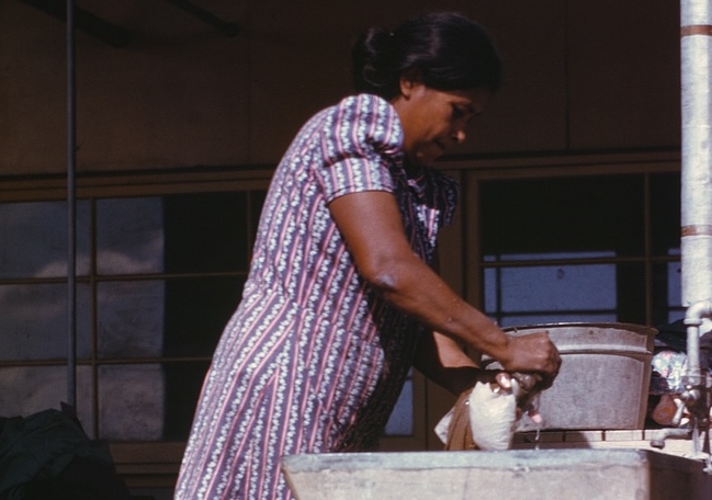 Woman at the community laundry on Saturday, Farm Security Administration labor camnp, Robstown, TX; Arthur Rothstein for the FSA. Library of Congress.